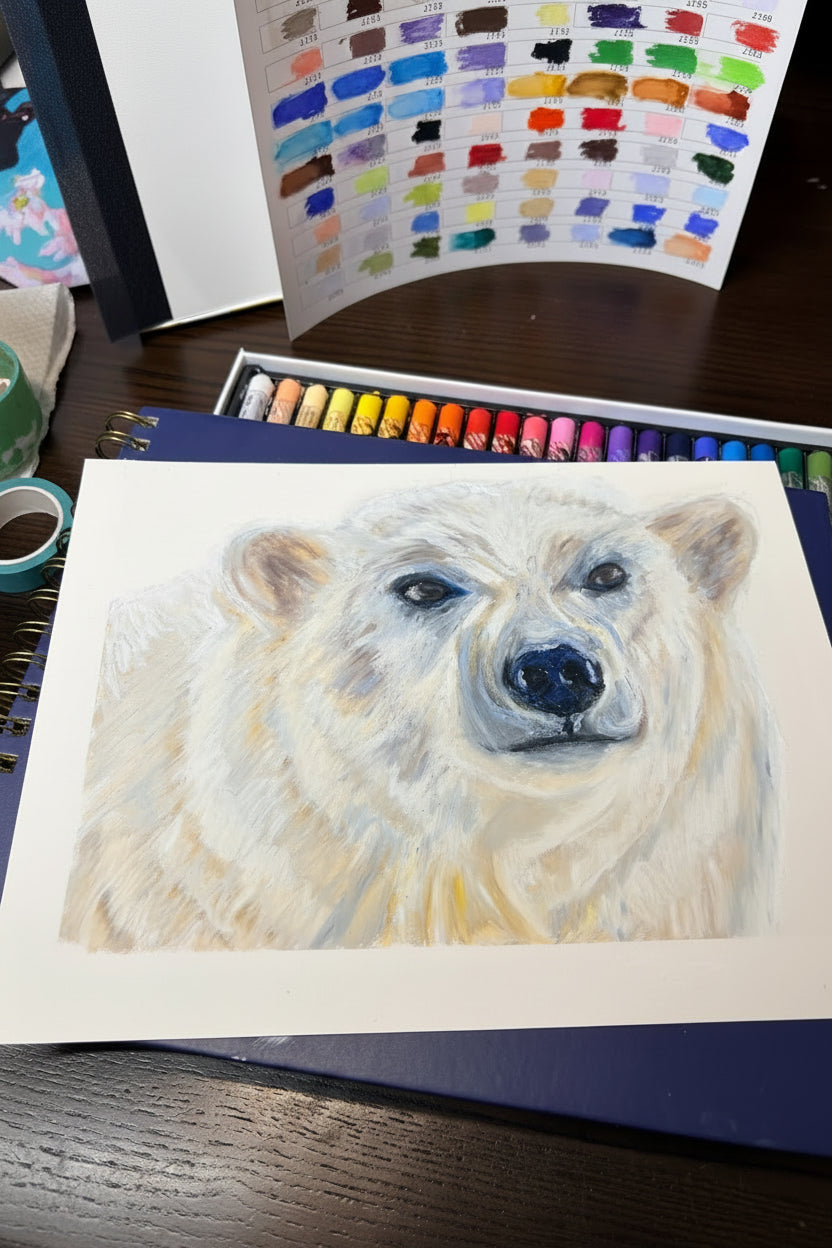 Artistic depiction of a polar bear with pastel crayons and color swatches in the background.