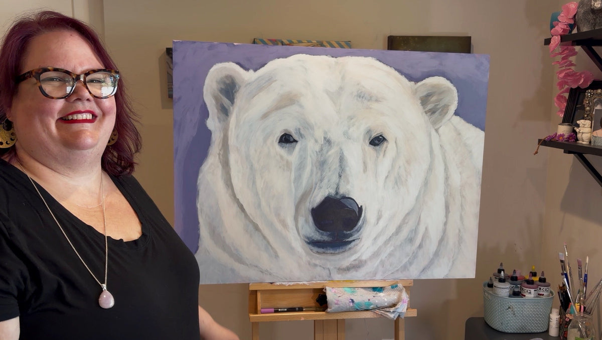 Tanya Mauldin in her studio in front of a painting of a polar bear